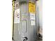 Rheem electric water heater with an energy guide and warning labels at 1172 Chelsea Ln, Holiday, FL 34691