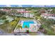 Aerial view of sparkling community pool with lounge chairs and lush landscaping for relaxed outdoor living at 2700 Bayshore Blvd # 2C/578, Dunedin, FL 34698