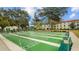 Community shuffleboard courts surrounded by mature trees at 2700 Bayshore Blvd # 2C/578, Dunedin, FL 34698