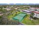 Aerial view of tennis court among lush green landscaping for active community residents at 2700 Bayshore Blvd # 2C/578, Dunedin, FL 34698