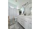 Bright bathroom with double vanity, modern fixtures and gray tile floors at 4154 Sinclair Pl, Land O Lakes, FL 34639