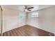 Well-lit bedroom featuring wood-look floors and two windows at 10162 115Th Ave, Largo, FL 33773