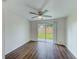Bright bedroom with wood-look floors and sliding glass door to backyard at 10162 115Th Ave, Largo, FL 33773