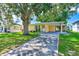Charming yellow house with carport, and green lawn at 10162 115Th Ave, Largo, FL 33773