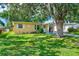 Ranch-style home with a large tree and spacious yard at 10162 115Th Ave, Largo, FL 33773