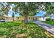 House with carport and spacious yard, tree in front at 10162 115Th Ave, Largo, FL 33773