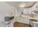 Modern kitchen with white cabinets, quartz countertops and stainless steel appliances at 10162 115Th Ave, Largo, FL 33773