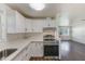 Modern kitchen with white cabinets, quartz countertops, and stainless steel appliances at 10162 115Th Ave, Largo, FL 33773