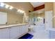 Bathroom with double sink vanity, tiled floors, and a soaking tub at 163 Brent Cir, Oldsmar, FL 34677