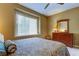 Cozy bedroom features a ceiling fan, natural light from window and matching dresser with mirror at 163 Brent Cir, Oldsmar, FL 34677