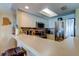 Bright kitchen featuring white cabinetry, stainless steel appliances, and breakfast bar seating at 163 Brent Cir, Oldsmar, FL 34677