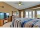 Bright main bedroom featuring vaulted ceiling, sliding glass doors with view and dresser with mirror at 163 Brent Cir, Oldsmar, FL 34677