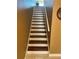 A bright staircase with white risers and dark wood treads leads up to a higher level at 163 Brent Cir, Oldsmar, FL 34677