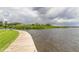 Beautiful waterfront view from the private dock on the property with lush green grass at 163 Brent Cir, Oldsmar, FL 34677