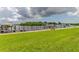 Expansive waterfront view featuring a lush green lawn, boats, and docks at 163 Brent Cir, Oldsmar, FL 34677