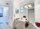 Bright bathroom featuring a vanity with sink, mirror, and white cabinets for storage at 2570 Gary Cir # 3, Dunedin, FL 34698