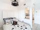 Bright bedroom featuring a queen bed and an open view to the kitchen at 2570 Gary Cir # 3, Dunedin, FL 34698