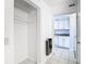 Hallway view with a closet and a glimpse into the white kitchen with tile floor at 2570 Gary Cir # 3, Dunedin, FL 34698