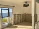 Partially renovated room with tile floors and a sliding glass door to a waterfront view at 2570 Gary Cir # 3, Dunedin, FL 34698