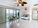 Bright living room with tile floors, ceiling fan, and waterfront views at 2570 Gary Cir # 3, Dunedin, FL 34698