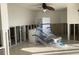 Spacious living room featuring tile floors, ceiling fan, and access to a waterfront view at 2570 Gary Cir # 3, Dunedin, FL 34698