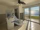 Living room featuring tile floors, ceiling fan, and sliding glass doors to a water view at 2570 Gary Cir # 3, Dunedin, FL 34698