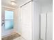Bright mud room with tile flooring, white door, and coat rack at 2570 Gary Cir # 3, Dunedin, FL 34698