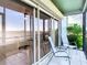Enclosed porch with seating area offers an exterior view and an area to sit and relax with views of the water at 2570 Gary Cir # 3, Dunedin, FL 34698