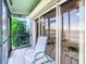 Enclosed porch with seating area offers an exterior view and an area to sit and relax with views of the water at 2570 Gary Cir # 3, Dunedin, FL 34698