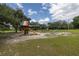 Community playground with playset, slide, and swings at 3130 Long Rifle Dr, Wimauma, FL 33598