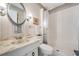 Bathroom featuring vanity with sink, toilet and a walk-in shower with a glass door at 2700 Bayshore Blvd # 559, Dunedin, FL 34698