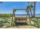 Scenic view of a swing overlooking the water and landscape with green grass and palm trees at 2700 Bayshore Blvd # 559, Dunedin, FL 34698