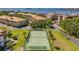 A tennis court surrounded by green lawns, landscaping and community buildings at 2700 Bayshore Blvd # 559, Dunedin, FL 34698