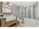 Bathroom with a farmhouse sink, subway tile and walk-in shower at 5000 Gulf Blvd # 704, St Pete Beach, FL 33706