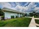 View of the home's exterior and landscaping with walkway at 7787 39Th N Ter # 7787, St Petersburg, FL 33709