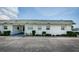 Side view of a white single story home with green accents at 7787 39Th N Ter # 7787, St Petersburg, FL 33709