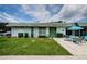 Front view of the home with green door and patio at 7787 39Th N Ter # 7787, St Petersburg, FL 33709