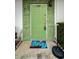 Green front door with a welcome mat and stone accents at 7787 39Th N Ter # 7787, St Petersburg, FL 33709