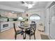 Bright kitchen with white appliances and a small dining area at 7787 39Th N Ter # 7787, St Petersburg, FL 33709