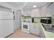 White kitchen with gas stove and ample counter space at 7787 39Th N Ter # 7787, St Petersburg, FL 33709