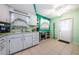 Open kitchen with white cabinets and teal walls at 7787 39Th N Ter # 7787, St Petersburg, FL 33709