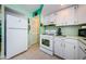 White appliances and teal walls in this kitchen at 7787 39Th N Ter # 7787, St Petersburg, FL 33709