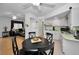 Kitchen features white appliances and a round dining table at 7787 39Th N Ter # 7787, St Petersburg, FL 33709