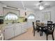 View of kitchen with dining area and white appliances at 7787 39Th N Ter # 7787, St Petersburg, FL 33709