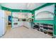 White appliances and teal walls in this galley kitchen at 7787 39Th N Ter # 7787, St Petersburg, FL 33709