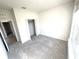 Well-lit bedroom with grey carpet and double door closet at 10188 Cross Timber Ter, Land O Lakes, FL 34638