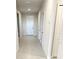 Bright hallway with tile floors and doors to bedrooms and bathroom at 10188 Cross Timber Ter, Land O Lakes, FL 34638