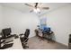 Home office with desk, chairs, and multiple monitors at 16135 Weathered Windmill Ter, Odessa, FL 33556