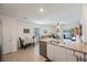 Kitchen with island, white cabinets, and granite countertops at 16135 Weathered Windmill Ter, Odessa, FL 33556