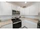 Kitchen with white cabinets and granite countertops at 16135 Weathered Windmill Ter, Odessa, FL 33556